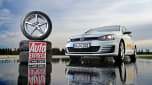 Volkswagen Golf Mk7 parked next to a stack of tyres